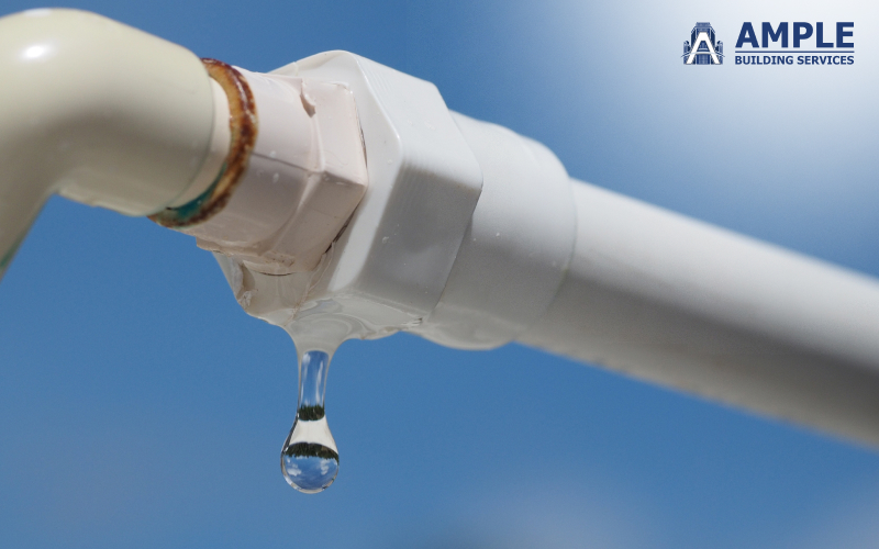 A water droplet leaking from a faulty pipe joint